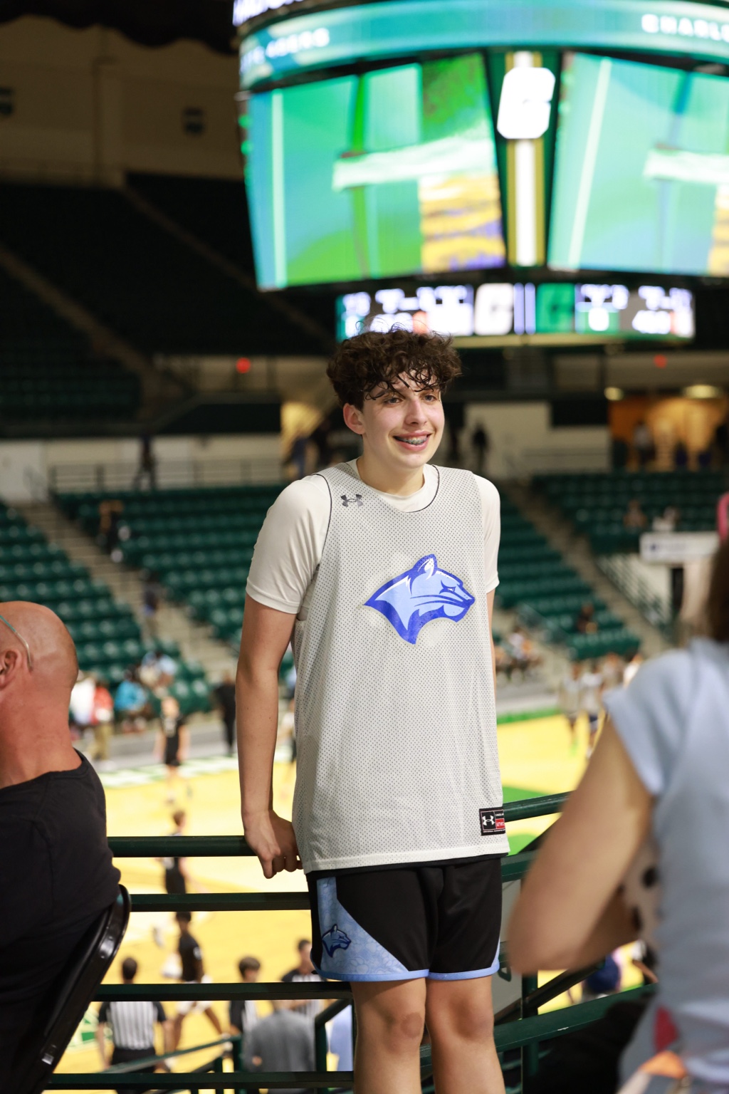 Noah smiling courtside in his basketball practice jersey